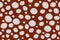 Deer skin color seamless pattern. Brown background with light rounded spots.