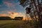 Deer stand tree stand beside field and forest at sunset light, Czech republic