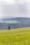 Deer stand, wooden hunters high seat hide on field, summer day, cloudy dramatic sky