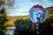 A defaced stop sign in the mountains with Castro\'s face