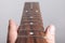 Defect fretboard of electric guitar in the hands of a master closeup