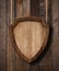 Defense protection shield shaped sign hanging on ropes with wood planks background