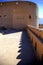 Defensive walls of the fort with scalloped shadows, Oman