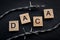 Deferred action for child arrivals concept with barb wire next to letters that spell the acronym DACA. DACA is a piece of