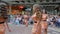 Defile, nice young contestants with long hair in dress and high heels pose on catwalk on beauty contest