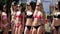 Defile of young women in bikinis in the aquapark