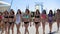 Defile of young women in bikinis in the aquapark