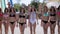 Defile of young women in bikinis in the aquapark