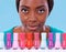 Define yourself with color. A young african woman looking over a row of colorful nail polish.