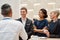 Define yourself. Group of businesspeople talking while having coffee, tea during break at business meeting, forum