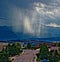 A Defined Shaft of Verga Rain Clouds and Mountains