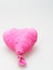 Deflate heart shape balloon in pink color isolated on white background