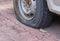 Deflated damaged tyre on car wheel