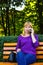 Defocus angry caucasian blond woman talking, speaking on the phone outside, outdoor. 40s years old woman in purple