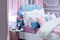 Defocus background of a beautiful bedroom in pastel pink blue. A large bed, a bunch of pillows, a bedside table with a lamp vase