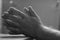 Defocus, blur, noise, grain effect. Close-up of men's hands fold