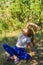 Defocus caucasian preteen girl practicing yoga in park, forest, outdoor, outside. Meditation, concentration. Healthy lifestyle.
