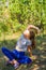 Defocus caucasian preteen girl practicing yoga in park, forest, outdoor, outside. Meditation, concentration. Wellness