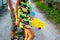 Defocus children holding yellow and blue penny board. Side view. Youth hipster culture. Close-up child hands holding