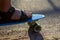 Defocus close-up little boy leg on a penny skateboard. Young kid riding in the park on a skateboard. Sunny and shadows