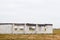 Defocus close-up white private unfinished brick house on a construction site on the autumn meadow village. Unfinished