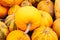 Defocus closeup a lot of yellow and green pumpkin at outdoor farmers market. Colorful stripe and spot varieties of