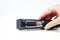 Defocus female hand holding electric clipper on white background. Professional hair clipper  on white background