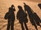 Defocus funny silhouettes of a family of three people on grains of beach sand