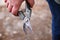 Defocus gardening scissors. Female hand holding gardening scissors closeup. Gardener with pruning shears in hand. Nature