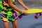 Defocus girl holding yellow penny board. Front view. Youth hipster culture. Child hands holding short cruiser pennyboard outdoors