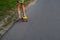 Defocus girl playing on yellow skateboard in the street and roadside. Caucasian kid riding penny board, practicing