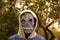 Defocus Halloween people portrait. Person in grim reaper mask standing on nature autumn background. Dark night mood