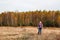 Defocus happy blond 40s woman standing in yellow autumn forest nature background. Happy beautiful lady. Women wearing