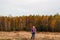 Defocus happy blond 40s woman standing in yellow autumn forest nature background. Happy beautiful lady. Women wearing
