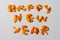 Defocus Happy New year word displayed by orange dry peel on a isolated white background. Decoration for New Year's Eve