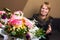 DEFOCUS Happy woman flowers. Beautiful middle-aged blonde woman feeling excited to receive lovely flower bouquet for