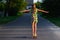 Defocus happy young girl playing on skateboard in the street. She put arms out to the sides. Caucasian kids riding penny