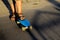 Defocus little urban boy standing on a blue penny skateboard. Young kid in the park. City style. Urban kids. Trendy