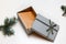 Defocus open gift box with craft envelope inside, Christmas tree