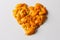 Defocus orange heart shaped Christmas background from the peels of orange and tangerine on a white background. Many