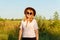 Defocus outdoor portrait of a beautiful blonde middle-aged woman in hat and sunglasses. Youth, wellness and lifestyle