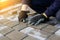 Defocus paver master. Man lays paving stones in layers. Garden brick pathway paving by professional worker. Hands of
