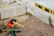 Defocus Paving garden. Yellow spirit level, hammer, mallet, chisel lie on the ground. Set of tools for laying paving