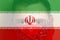 Defocus protest in Iran. Face young man in bandana. Conflict war over border. Closeup man face. Country flag. Iran flag