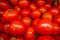 Defocus red tomatoes.tray market agriculture of tomatoes,used as background,close up view