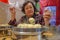 Defocus Senior Asian women eating Small Steam Buns in Chinese Restaurant