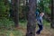 Defocus side view of two woman walking in pine forest. Mushroom picking season, leisure and people concept, mother and