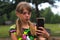 Defocus surprised ten year old girl find something on smart phone. Beautiful teenage girl takes selfie while standing