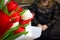 DEFOCUS Tulip women background. Bouquet of colorful tulips with blurred woman on background Happy Mother& x27;s Day concept