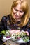 Defocus Woman flowers. A woman admires a gorgeous bouquet. The blonde looks at a beautiful flower arrangement